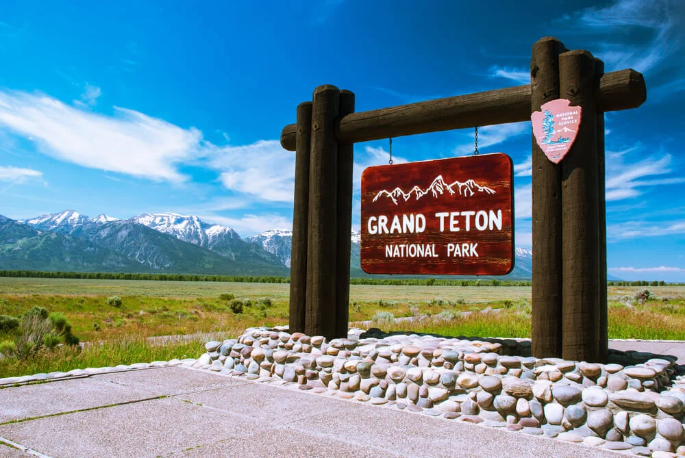 GTNP Sign in front of mountains